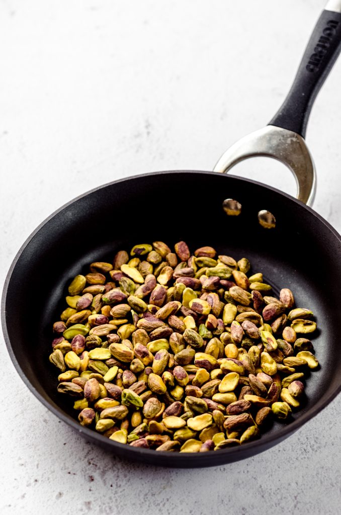 Pistachios in a skillet ready to toast.
