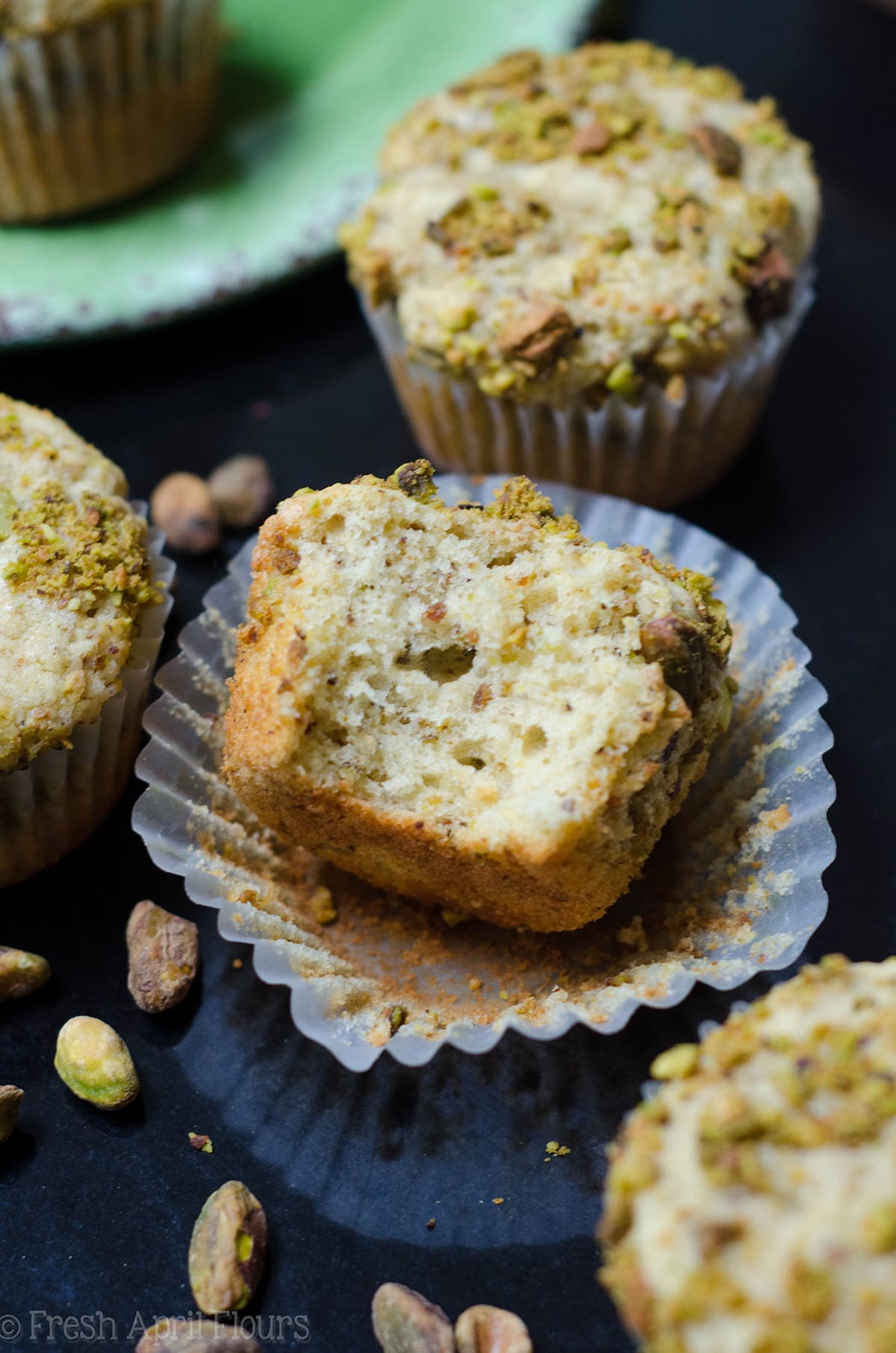 pistachio muffin with a bite taken out of it