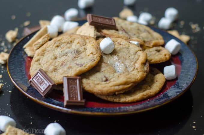 S'mores Cookies: Classic milk chocolate chip cookies scattered with gooey marshmallows and crunchy graham cracker crumbs.