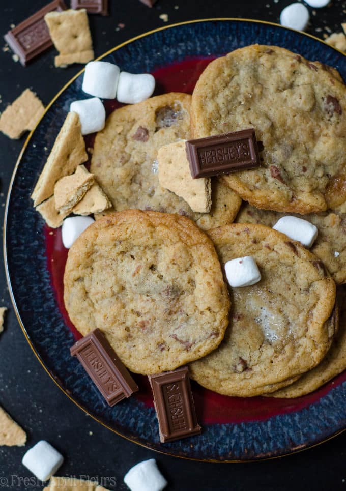 S'mores Cookies: Classic milk chocolate chip cookies scattered with gooey marshmallows and crunchy graham cracker crumbs.