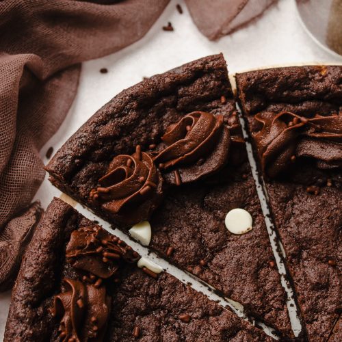 Aerial photo of a triple chocolate cookie cake that has been cut into slices.