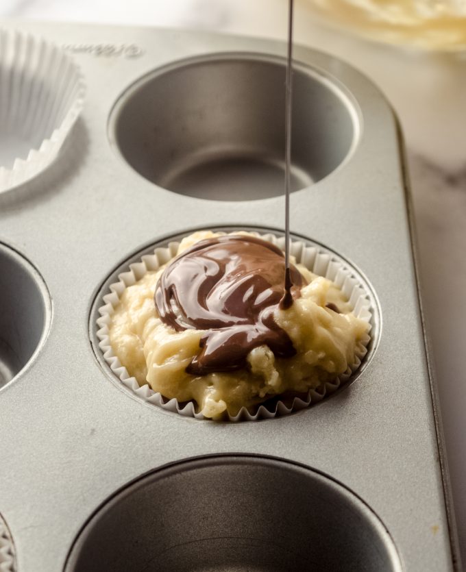 Someone is swirling Nutella into muffin batter.