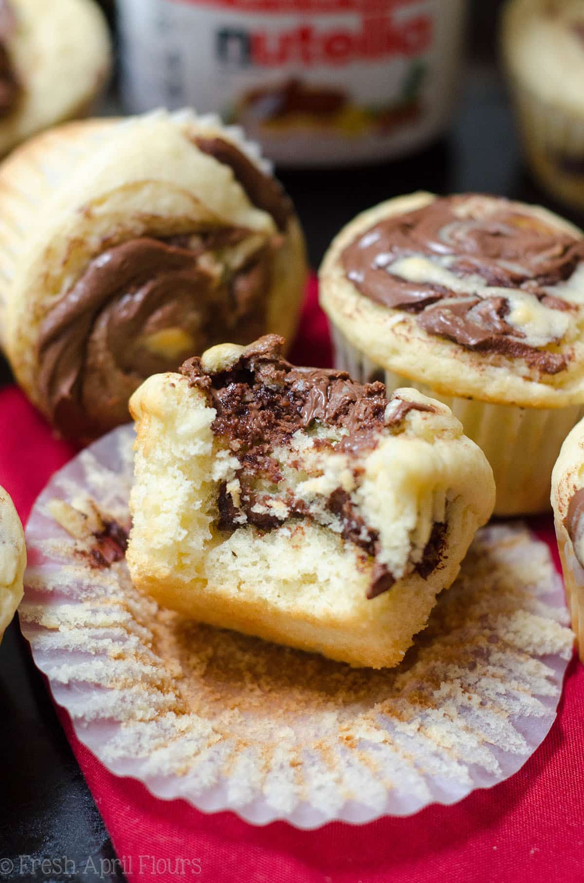 nutella swirl muffin unwrapped and with a bite taken out of it