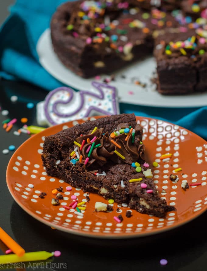 Triple Chocolate Cookie Cake: Dark chocolate cookie cake filled with creamy white chocolate chips and topped with a chocolate fudge frosting.