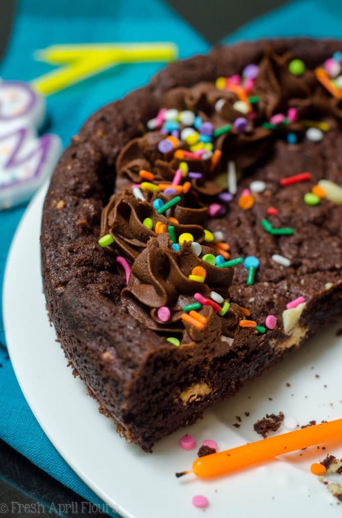 Triple Chocolate Cookie Cake: Dark chocolate cookie cake filled with creamy white chocolate chips and topped with a chocolate fudge frosting.