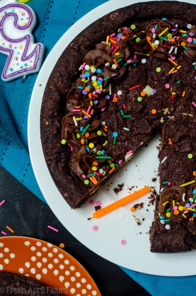 Triple Chocolate Cookie Cake: Dark chocolate cookie cake filled with creamy white chocolate chips and topped with a chocolate fudge frosting.