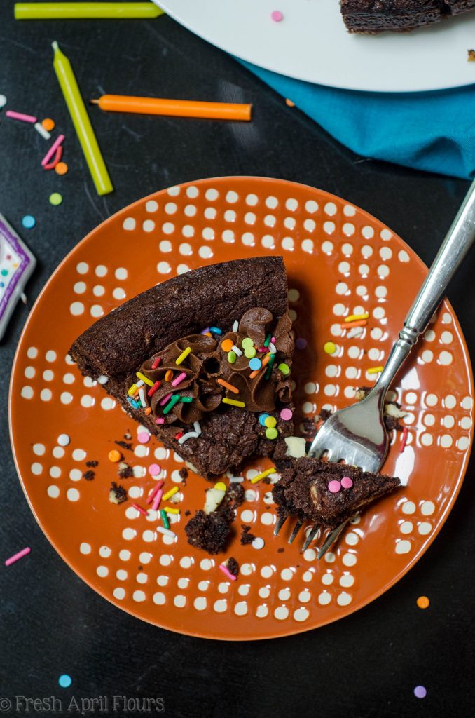 Triple Chocolate Cookie Cake: Dark chocolate cookie cake filled with creamy white chocolate chips and topped with a chocolate fudge frosting.