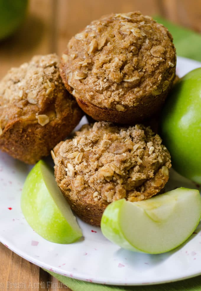 Apple Cinnamon Oat Streusel Muffins: Moist and tender muffins full of tart, chunky apples and topped with a melt-in-your-mouth cinnamon and oat streusel. A great staple muffin recipe for fall!