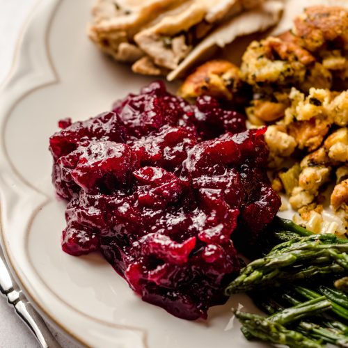 spiced cranberry sauce on a plate with thanksgiving sides