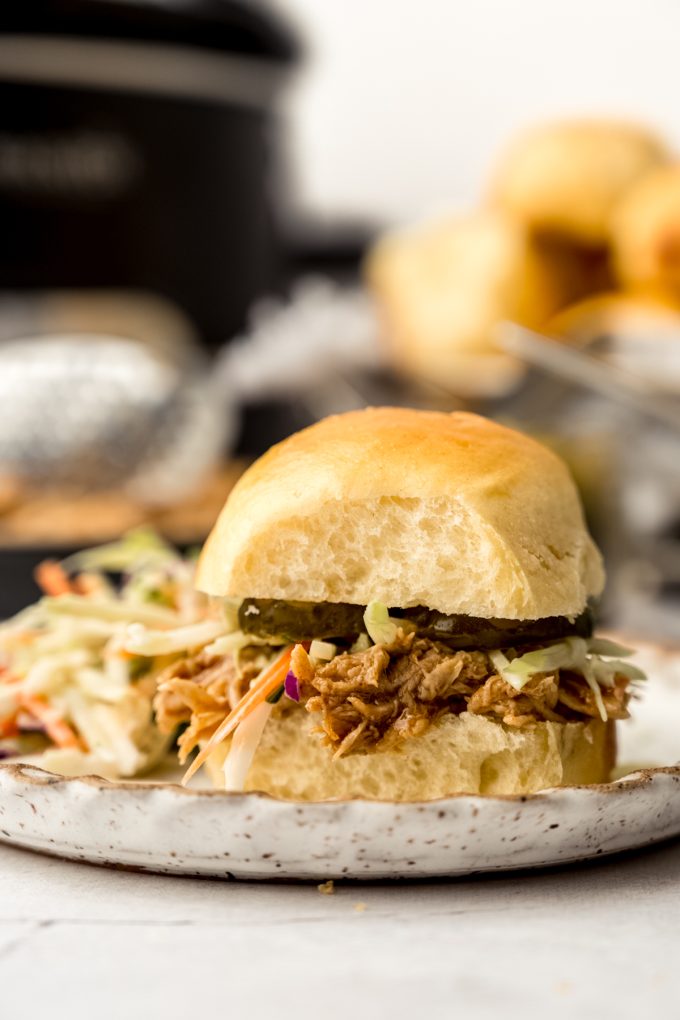 A shredded hot chicken sandwich on a plate.