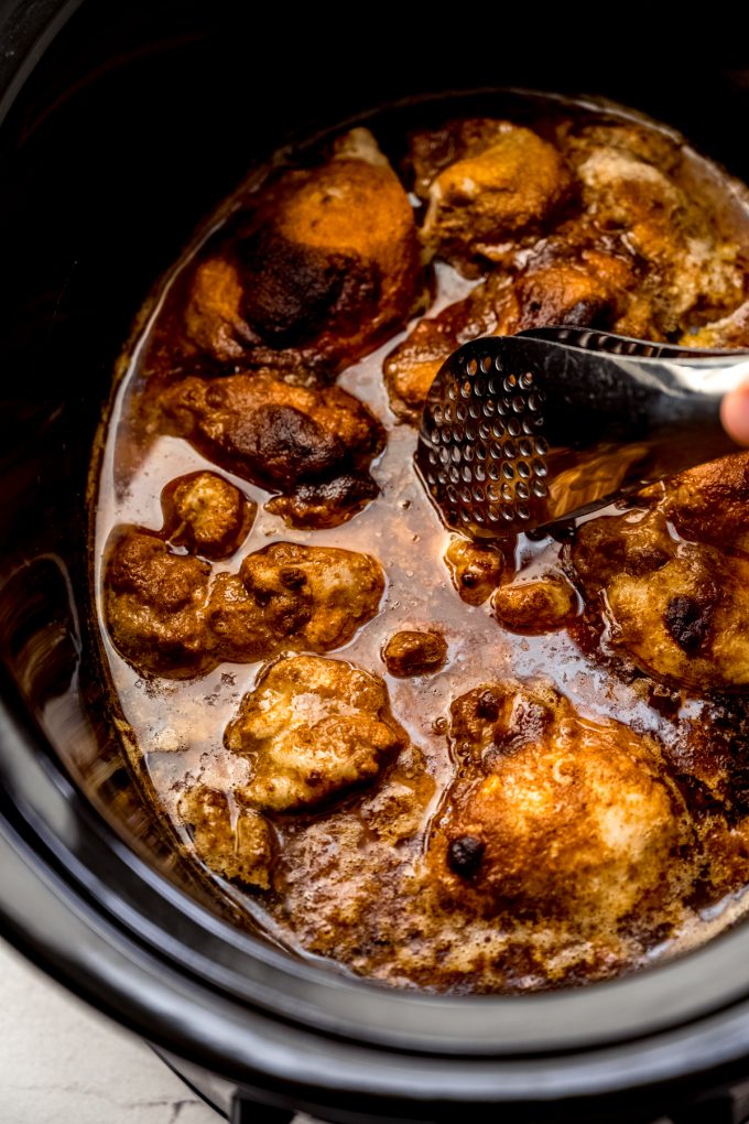 A slow cooker filled with hot chicken.
