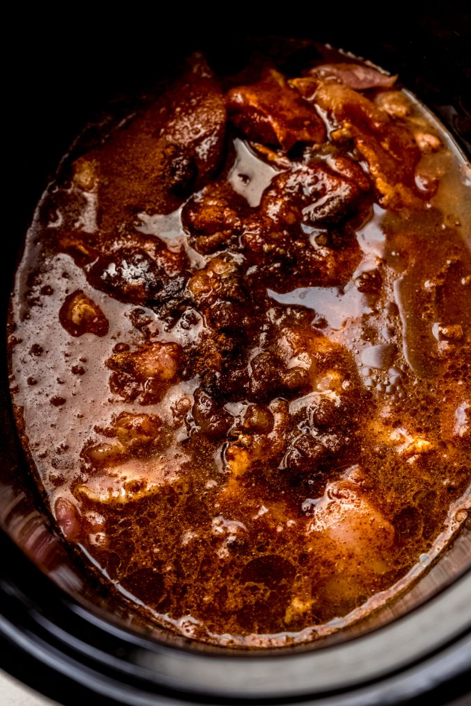 A slow cooker filled with hot chicken.