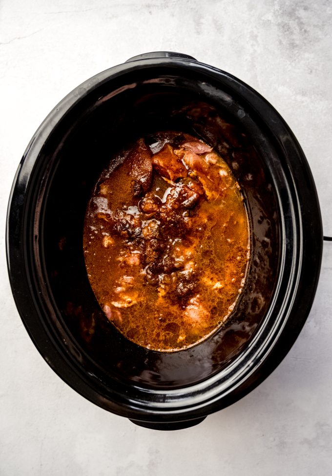 A slow cooker filled with hot chicken.