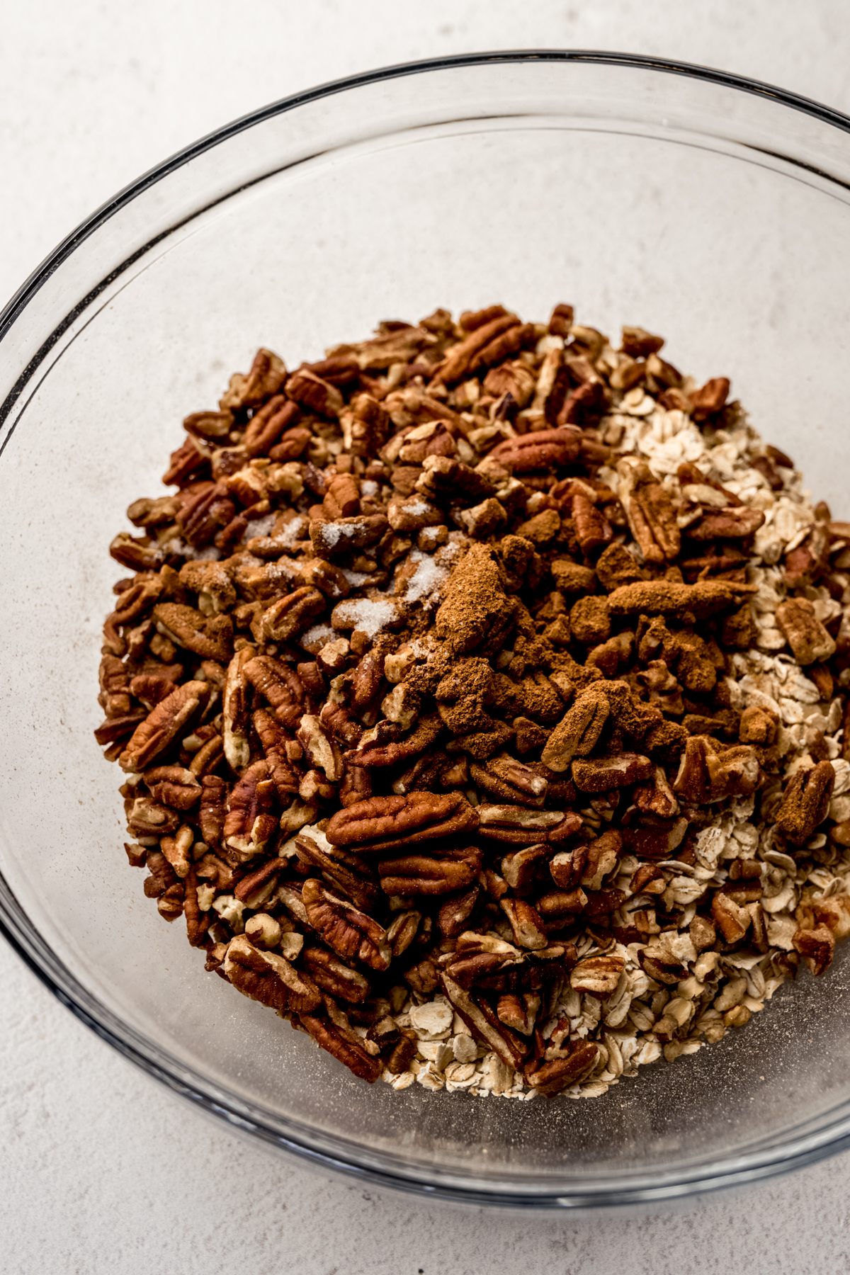 A bowl of oats, nuts, and other ingredients to make the base for pumpkin granola.