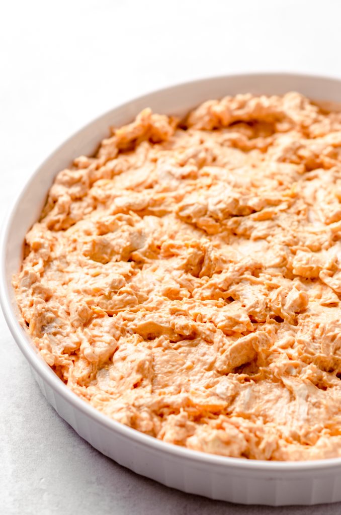 Buffalo chicken dip in a dish before being baked.