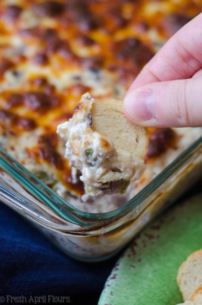 Philly Cheesesteak Dip: Creamy dip filled with flavorful onions, green pepper, mushrooms, and roast beef, topped with a crispy layer of provolone cheese.