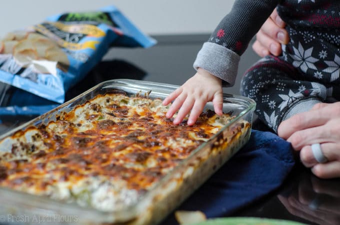 Philly Cheesesteak Dip: Creamy dip filled with flavorful onions, green pepper, mushrooms, and roast beef, topped with a crispy layer of provolone cheese.