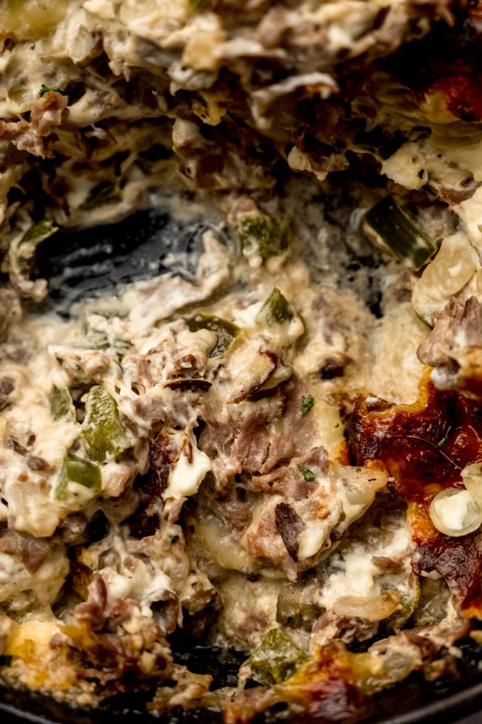 Philly cheesesteak dip in a skillet.