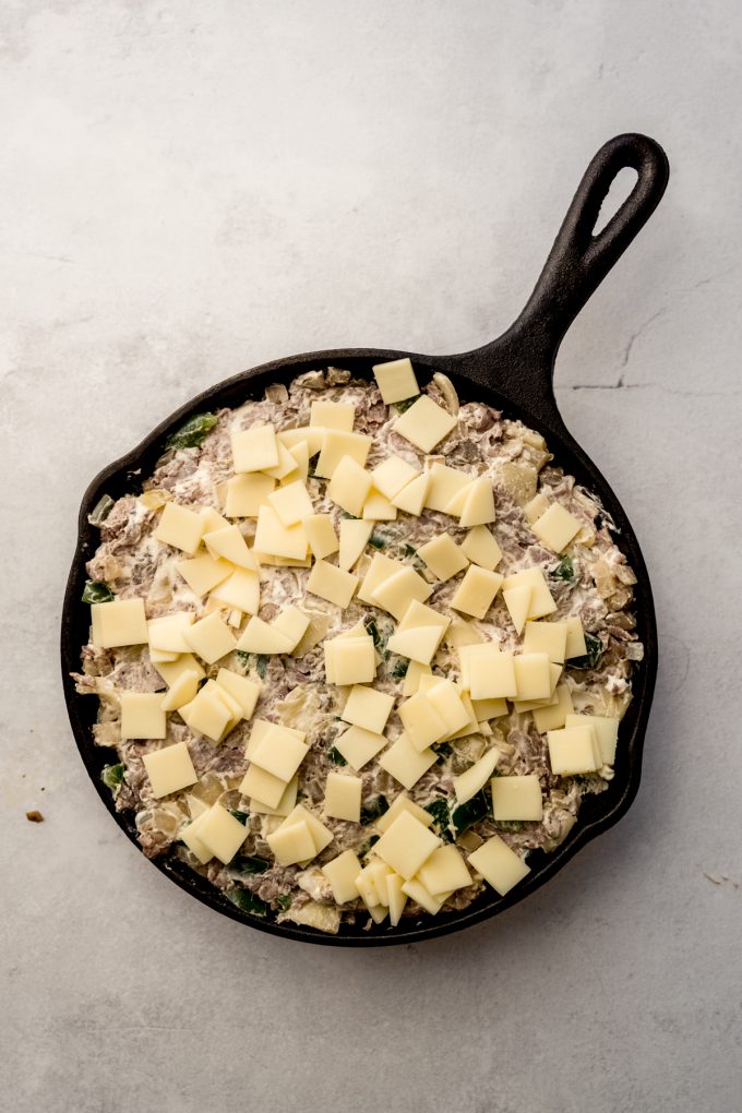Aerial photo of Philly cheesesteak dip in a skillet before baking.