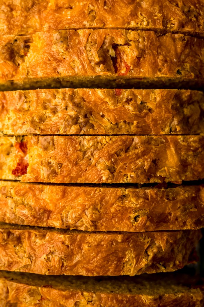 Aerial photo of tomato basil bread loaf that has been sliced.