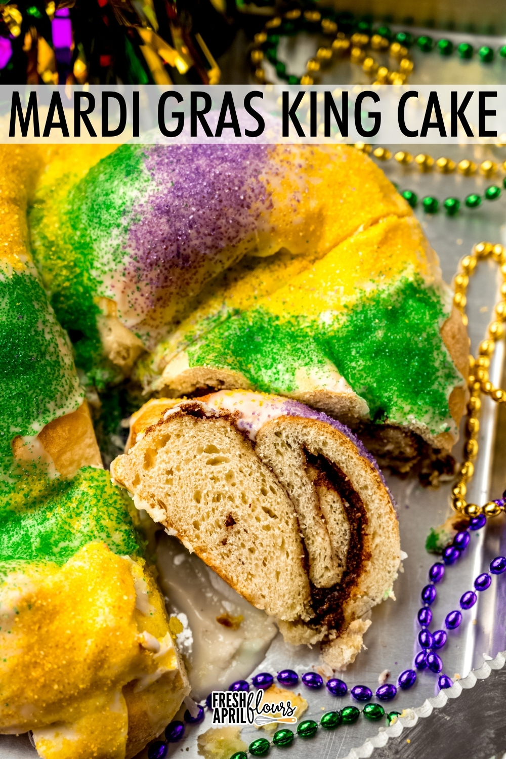 This traditional Mardi Gras King cake recipe is worlds better than anything you can buy at the grocery store. This simple spiced yeast dough gets filled with a cinnamon sugar filling, twisted into a ring, and adorned with colored sugar. Add a tiny plastic baby to pull the tradition full circle! via @frshaprilflours