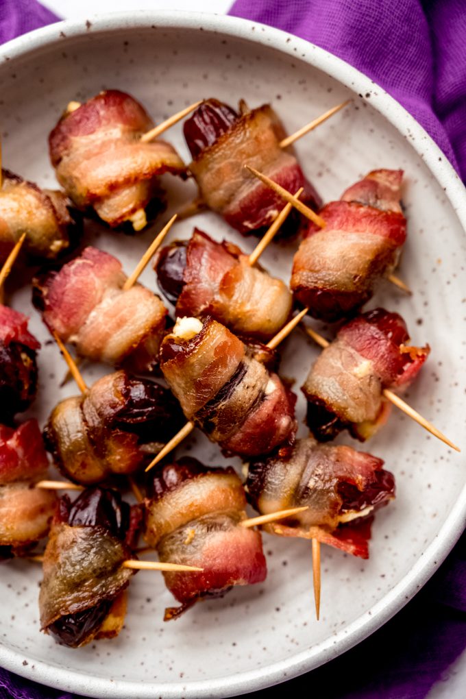 A plate of bacon wrapped goat cheese stuffed dates.