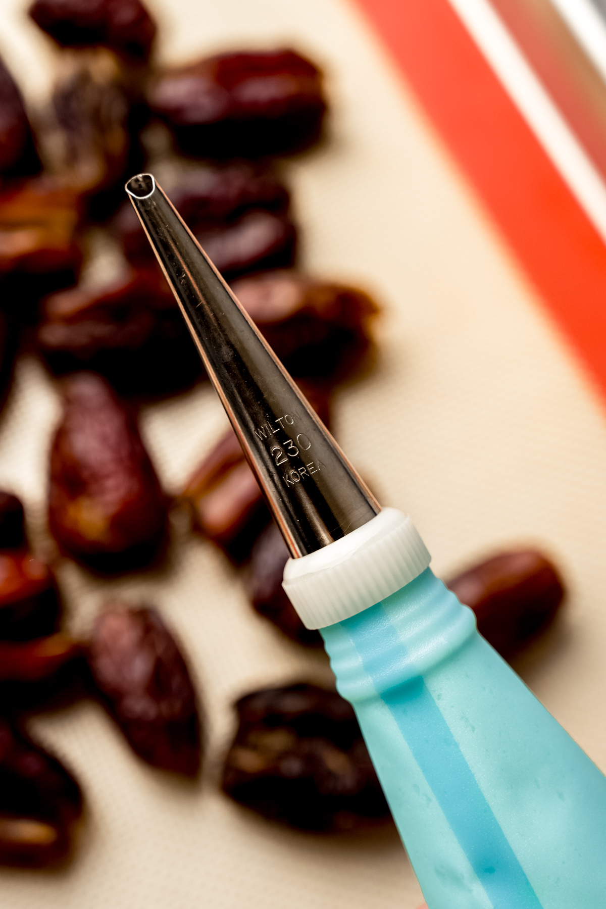 A piping bag fitted with a 230 tip.