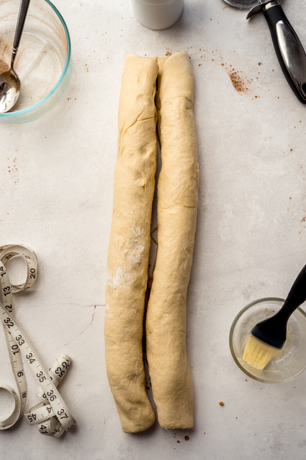Two logs of filled dough on a surface.