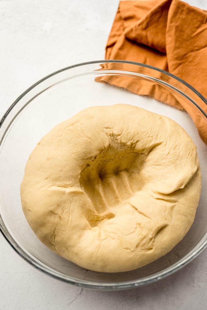 Yeast dough in a bowl after it has been punched down.