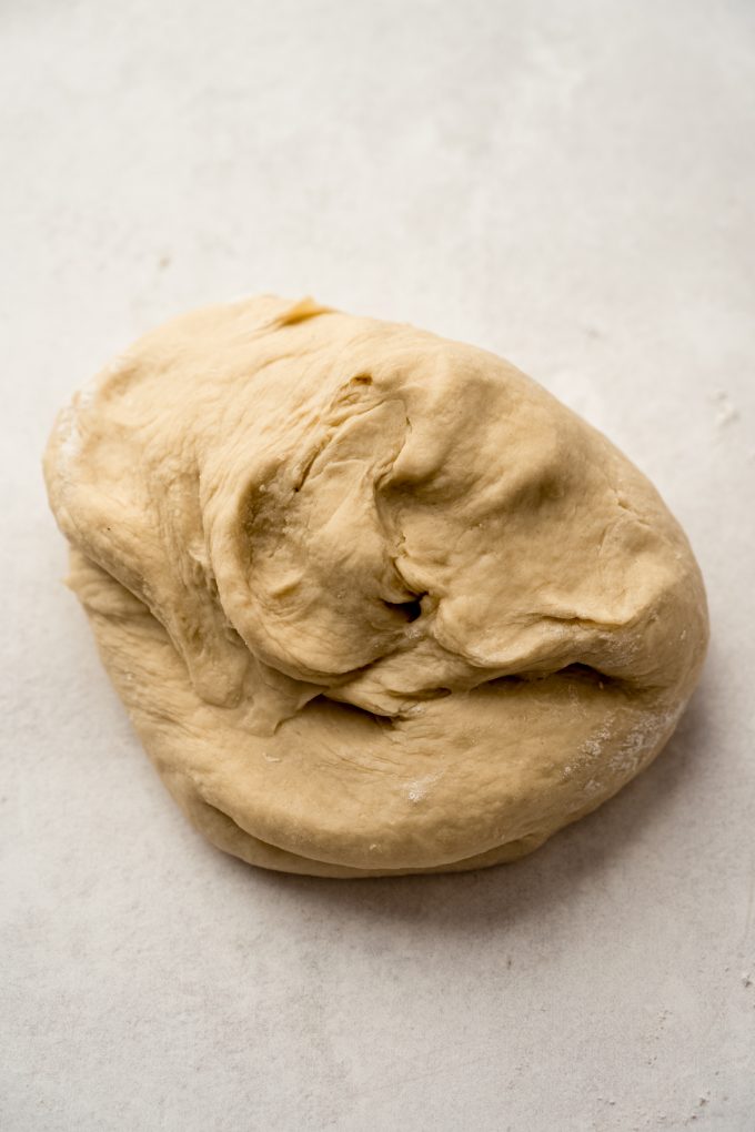 A ball of yeast dough on a surface.
