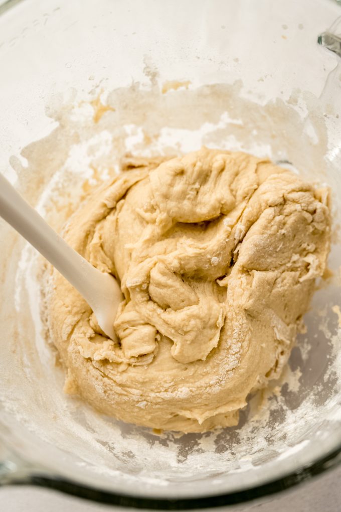 Yeast dough in the mixing bowl of a stand mixer.