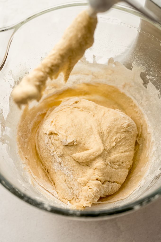 Yeast dough in the mixing bowl of a stand mixer.