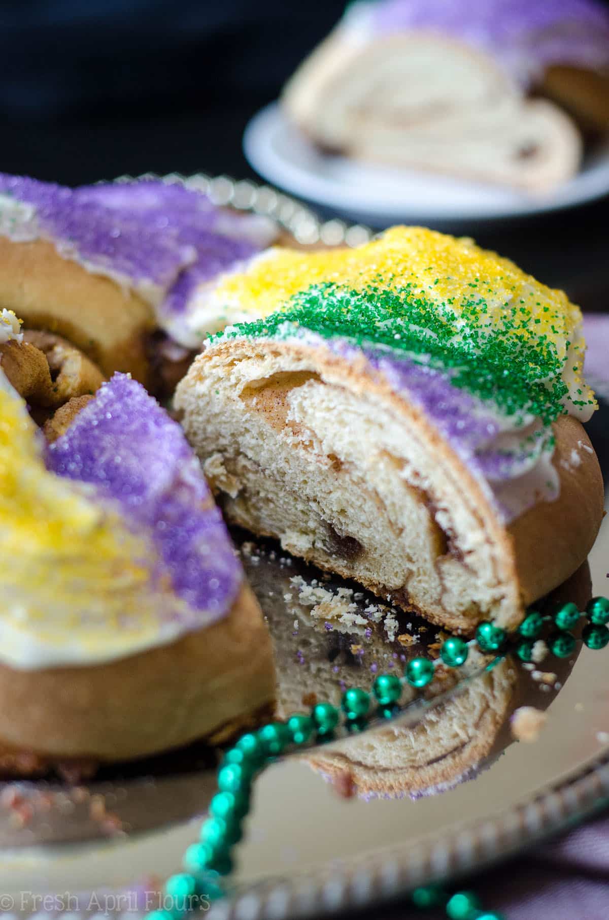 sliced mardi gras king cake on a platter