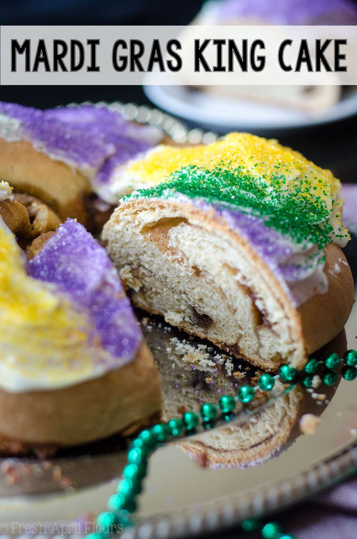This traditional Mardi Gras King cake is worlds better than anything you can buy at the grocery store. This simple spiced yeast dough gets filled with a cinnamon sugar filling, twisted into a ring, and adorned with colored sugar. Add a tiny plastic baby to pull the tradition full circle! via @frshaprilflours