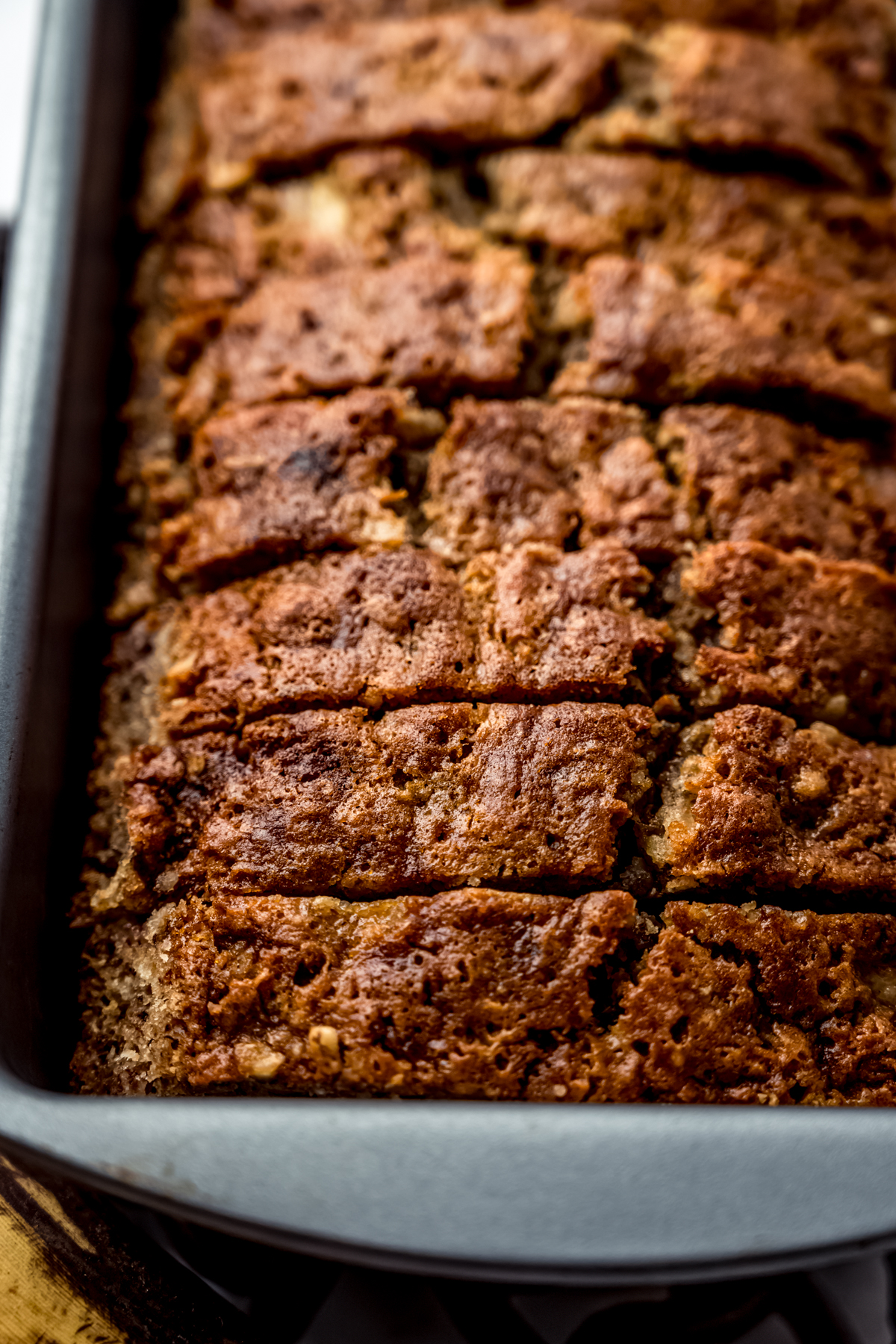 Slices of banana nut bread in a baking pan.