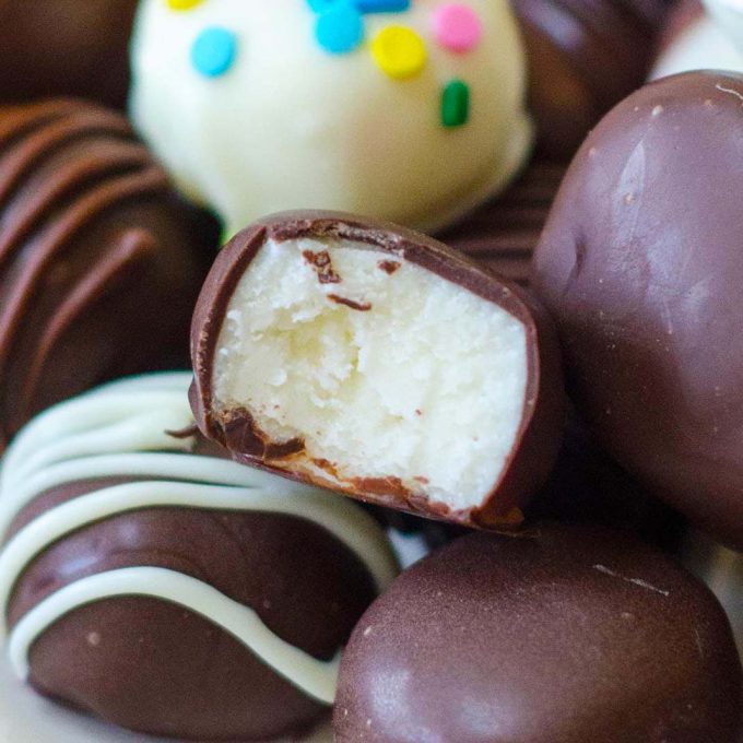 A buttercream Easter candy coated in chocolate with a bite taken out of it.