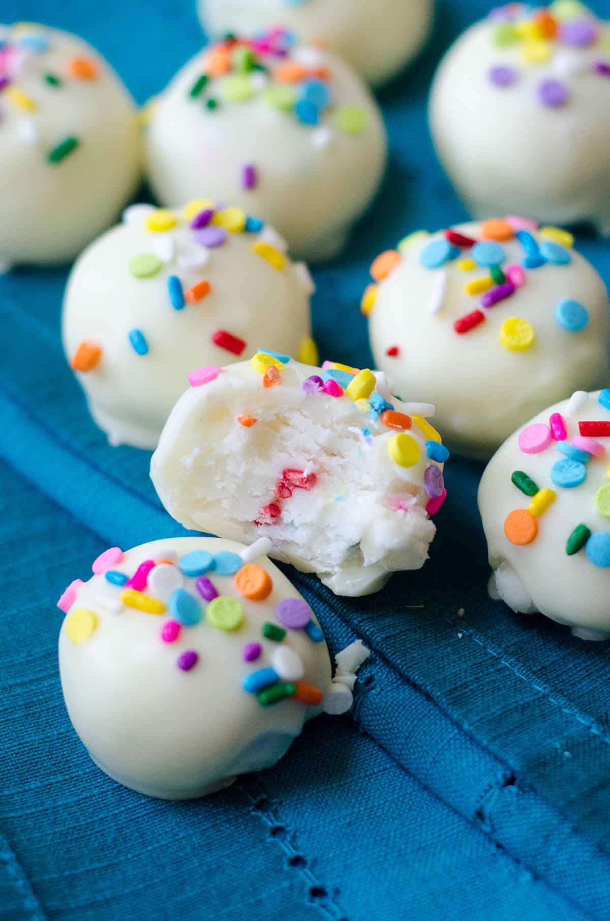 funfetti buttercreams covered in white chocolate and topped with sprinkles