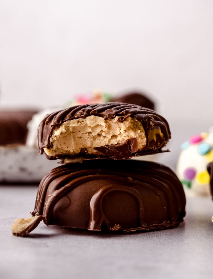 A stack of two peanut butter Easter eggs and a bite has been taken out of the one on the top.