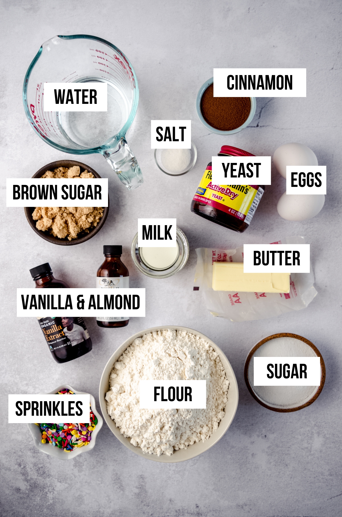 Aerial photo of ingredients for funfetti cinnamon rolls with text overlay.