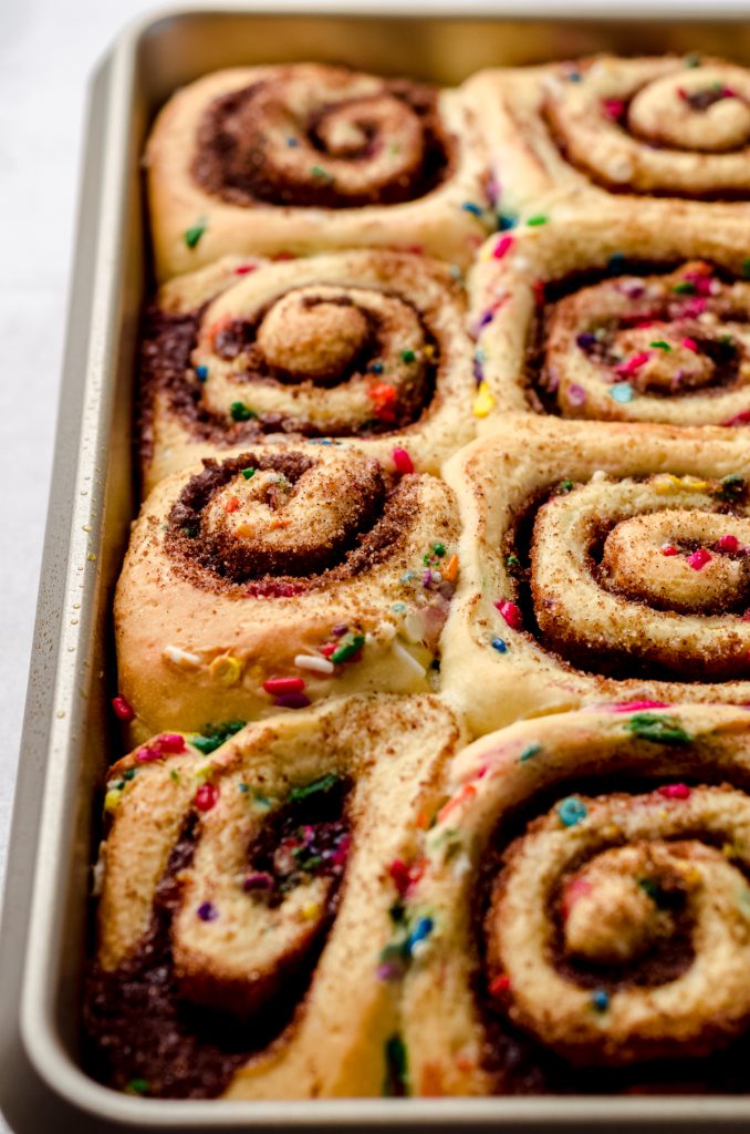 Baked funfetti cinnamon rolls in a baking pan before someone added frosting.