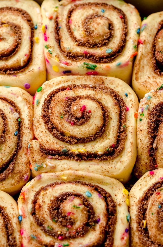 Closeup of proofed funfetti cinnamon rolls.