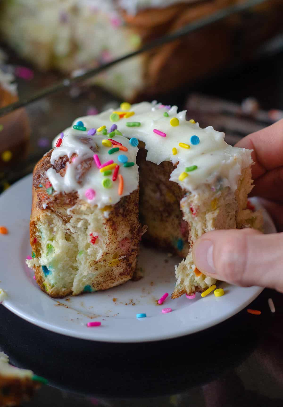 Simple yeast rolls filled with sweet and gooey cinnamon and studded with sprinkles. Spread with easy cream cheese frosting for an indulgent breakfast or treat! via @frshaprilflours