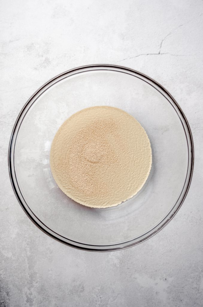 Aerial photo of yeast in a large glass bowl before proofing.