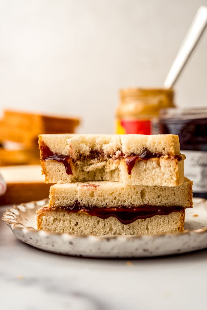 A peanut butter and jelly sandwich sliced in half and stacked on top each other so you can see the cross section.