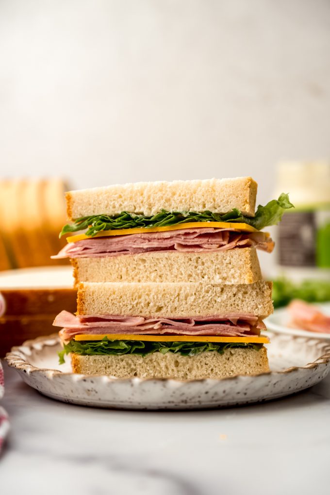 A ham and cheese sandwich sliced in half and stacked on top each other so you can see the cross section.