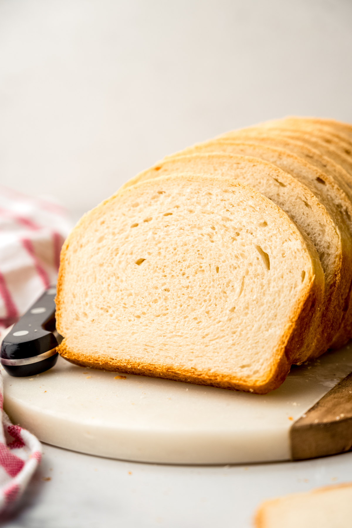 Sliced sandwich bread on a surface.