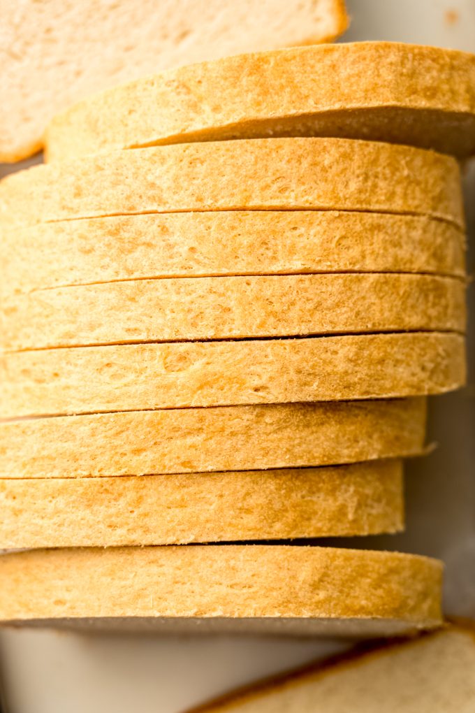 Sliced sandwich bread on a surface.