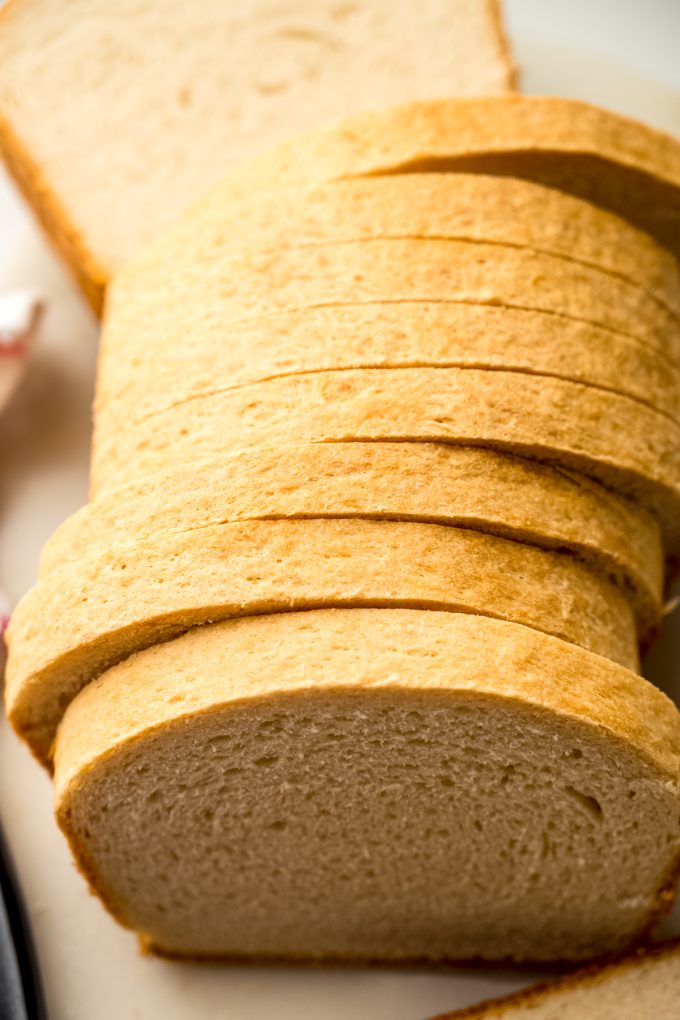 Sliced sandwich bread on a surface.