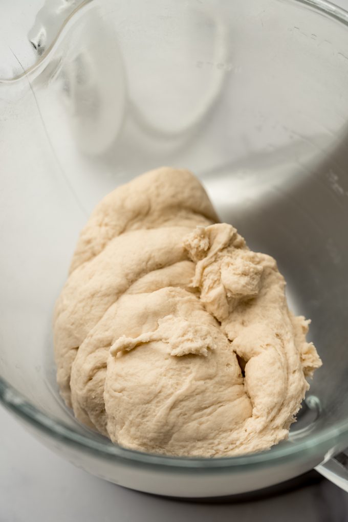 Yeast bread dough in the bowl of a stand mixer.