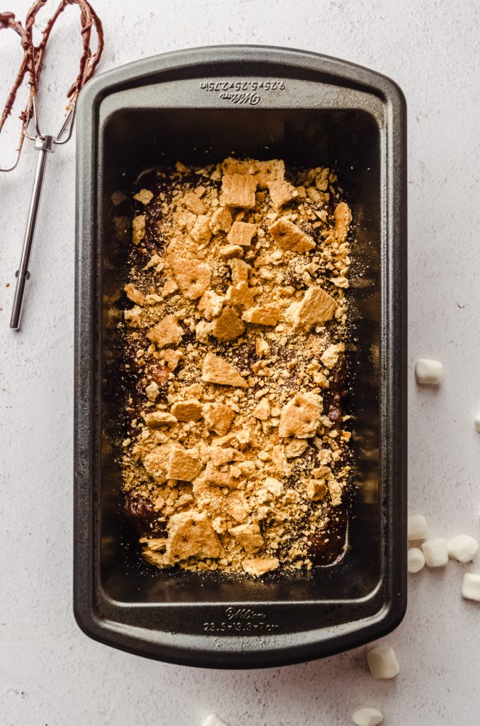 Aerial photo of the graham cracker layer in s'mores quick bread in a baking pan.